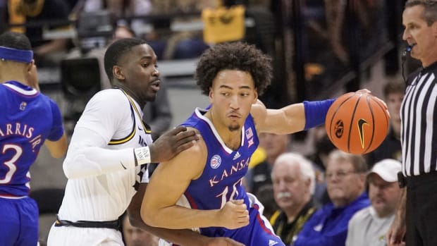 Dec 10, 2022; Columbia, Missouri, USA; Kansas Jayhawks forward Jalen Wilson (10) dribbles the ball as Missouri Tigers guard D'Moi Hodge (5) defends during the first half at Mizzou Arena. Mandatory Credit: Denny Medley-USA TODAY Sports